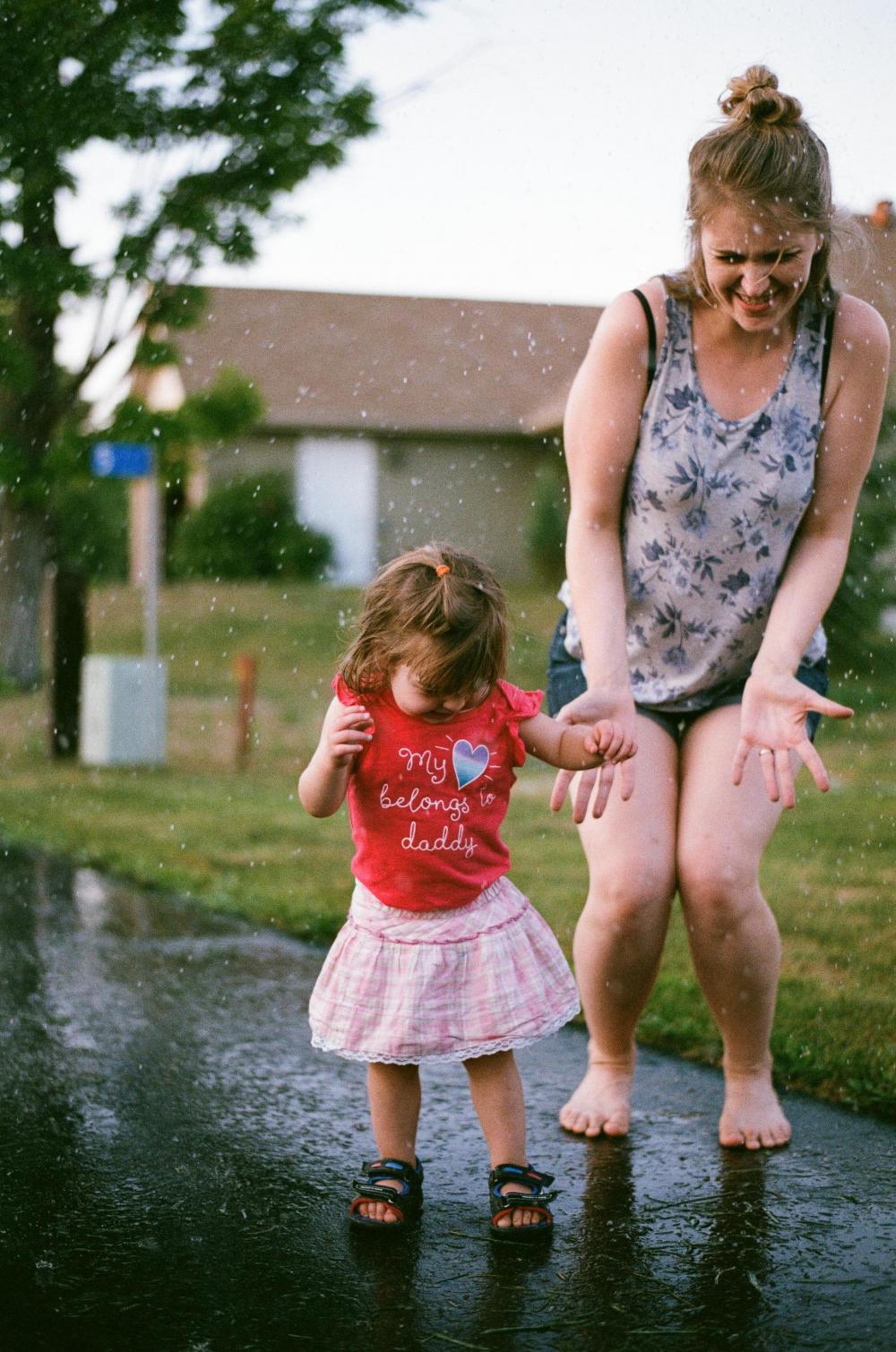 Woman And Girl Play With Water Photo Woman And Girl Play With Water Photo