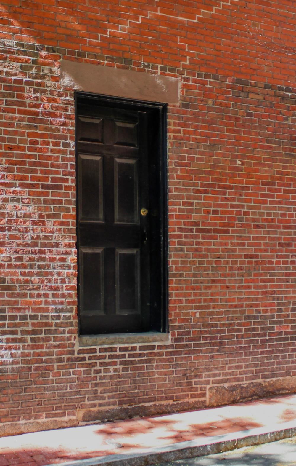 brick wall door sidewalk street brick wall door sidewalk street