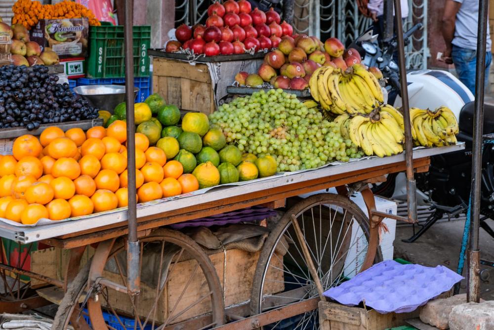 Street Vendor Selling Fruits on His Fruit Cart Street Vendor Selling Fruits on His Fruit Cart