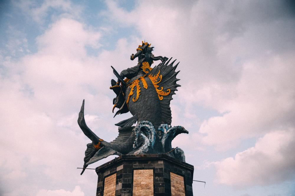 A Statue Of Poseidon Riding A Large Fish On A Wave Photo A Statue Of Poseidon Riding A Large Fish On A Wave Photo