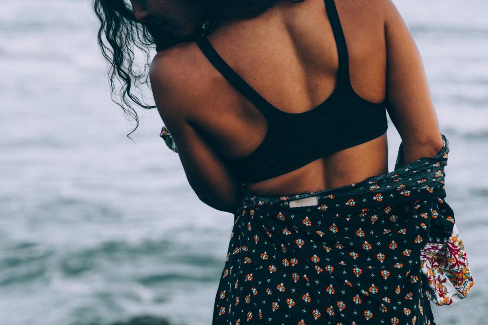 A Tanned Woman In A Beach Robe Stands By The Sea Photo A Tanned Woman In A Beach Robe Stands By The Sea Photo