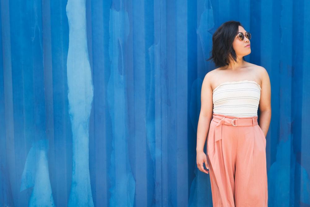 A Woman Against A Primary Blue Wall Photo A Woman Against A Primary Blue Wall Photo