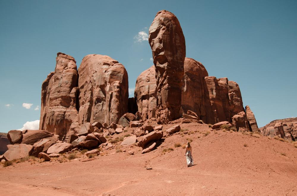 A Woman Looks Up At Stubby Stone Fingers Of Desert Mountains Photo A Woman Looks Up At Stubby Stone Fingers Of Desert Mountains Photo