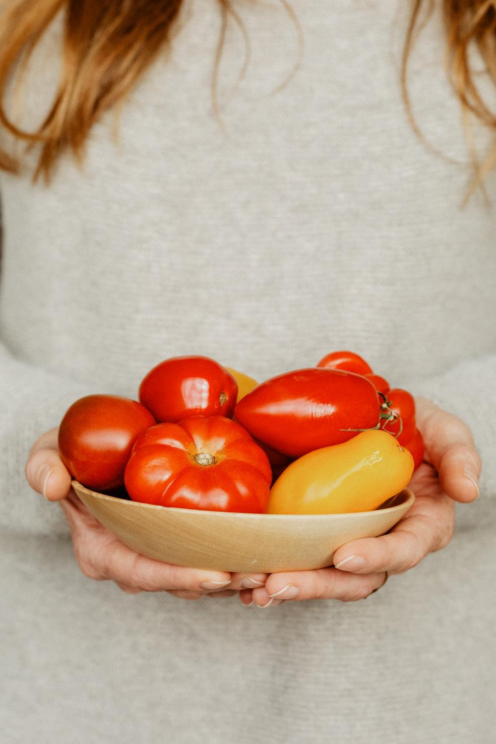 A Woman With A Bowl Of Tomatoes And Peppers Photo A Woman With A Bowl Of Tomatoes And Peppers Photo