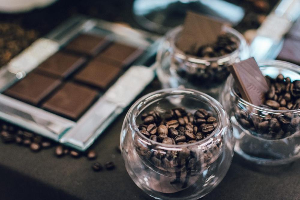 Dark chocolate bar and coffee beans in glasses Dark chocolate bar and coffee beans in glasses