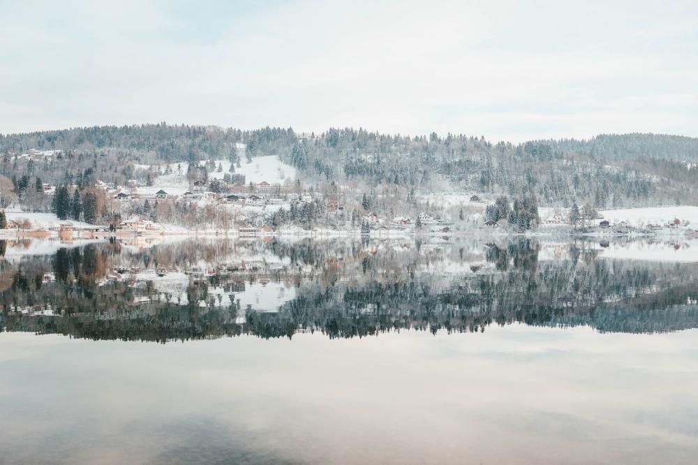 An Icy Lake Under Snowy And Snowy Hills under Frosty Sky Photo An Icy Lake Under Snowy And Snowy Hills under Frosty Sky Photo