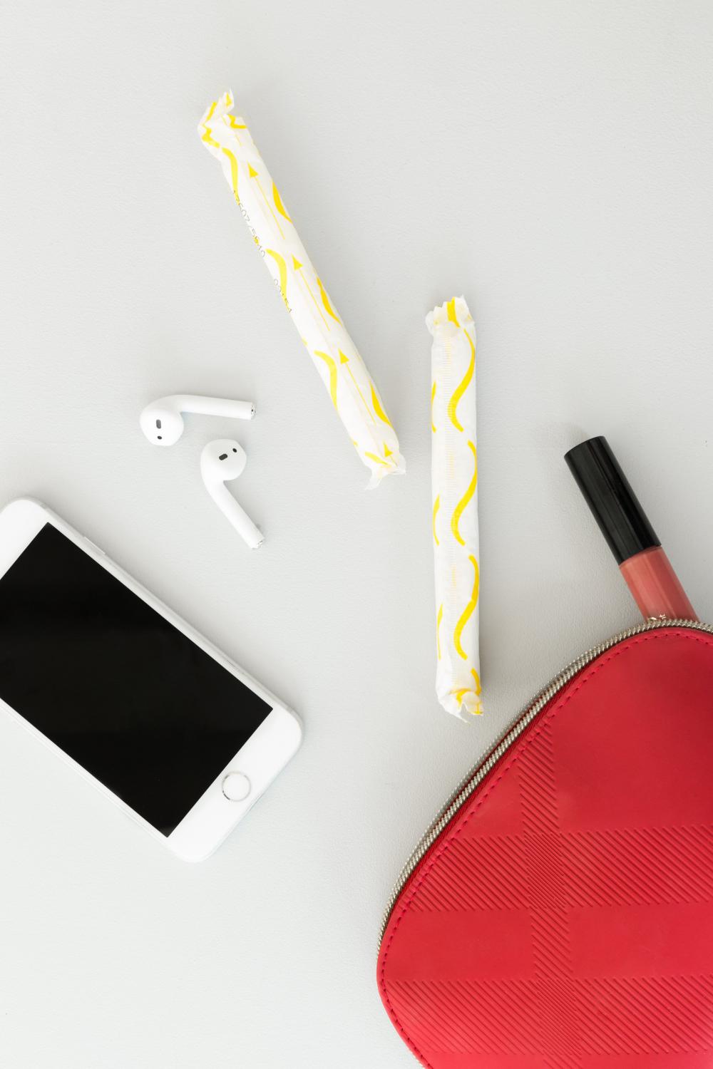 A Red Purse Spills Feminine Products Onto A Table Photo A Red Purse Spills Feminine Products Onto A Table Photo