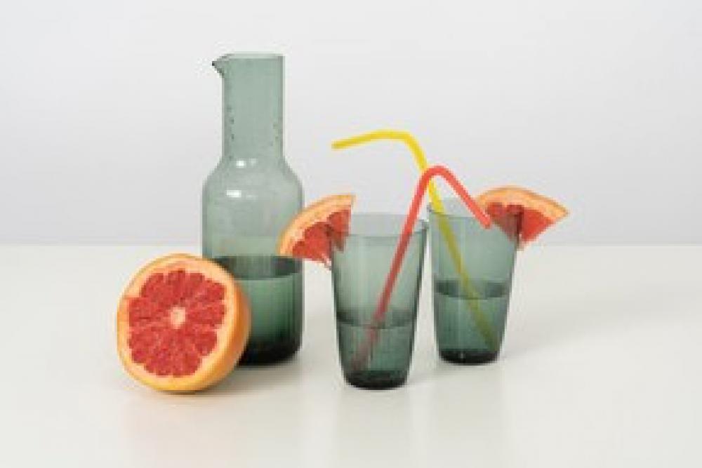 A Glass Bottle And Glasses With Some Cold Water And Slices Of A Grapefruit, Along With Some Colourful Plastic Straws A Glass Bottle And Glasses With Some Cold Water And Slices Of A Grapefruit, Along With Some Colourful Plastic Straws
