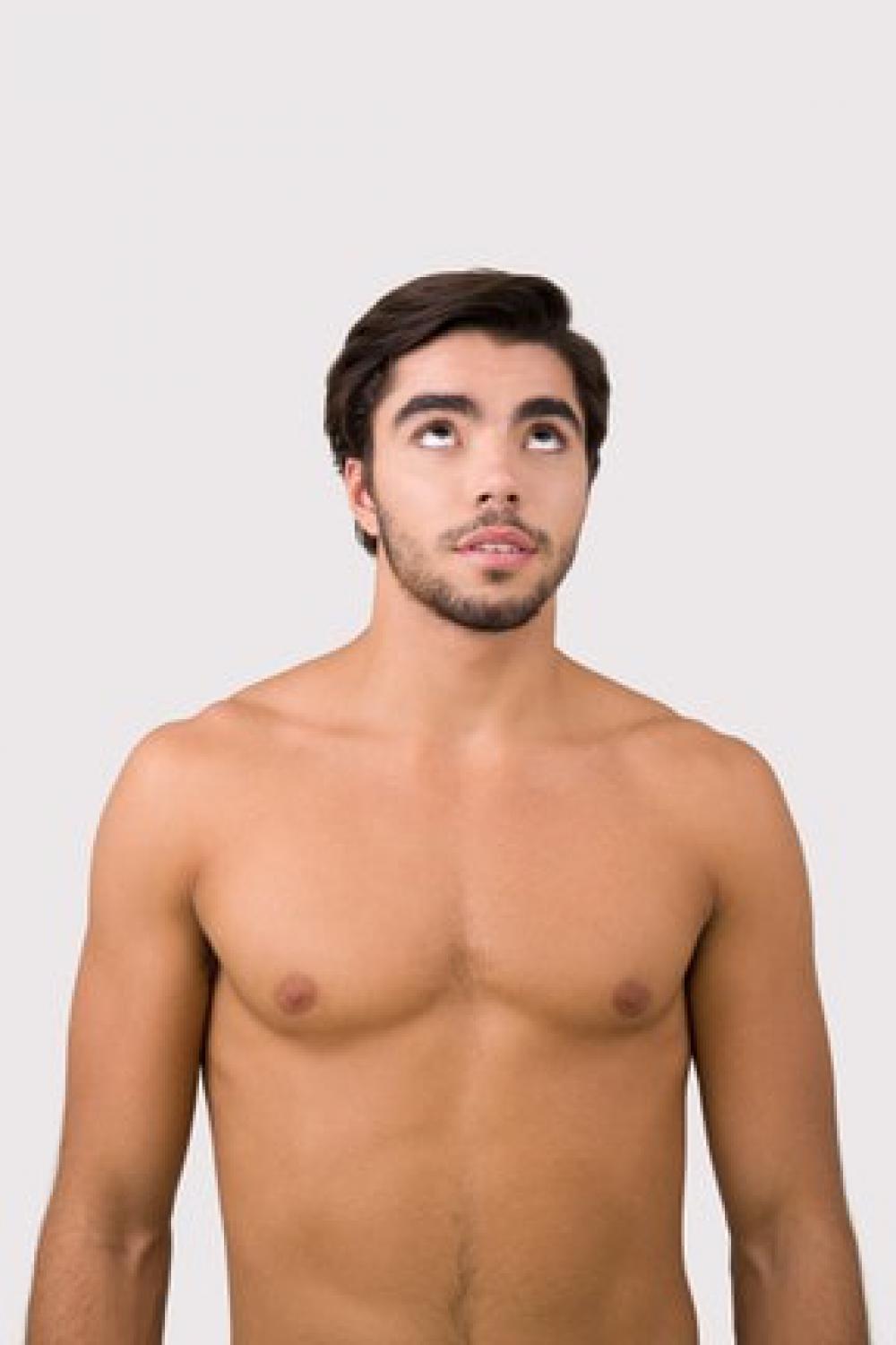 Young Attractive Man Standing With His Eyes Rolled Up Young Attractive Man Standing With His Eyes Rolled Up
