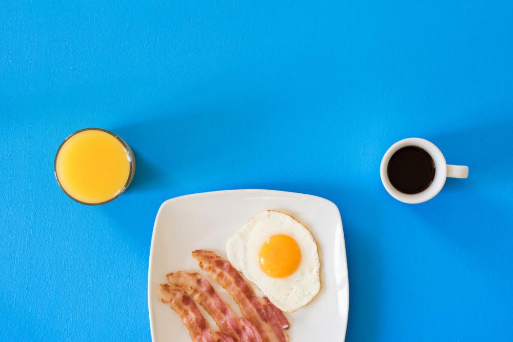 Coffee, Orange Juice, Bacon Blue Background Coffee, Orange Juice, Bacon Blue Background