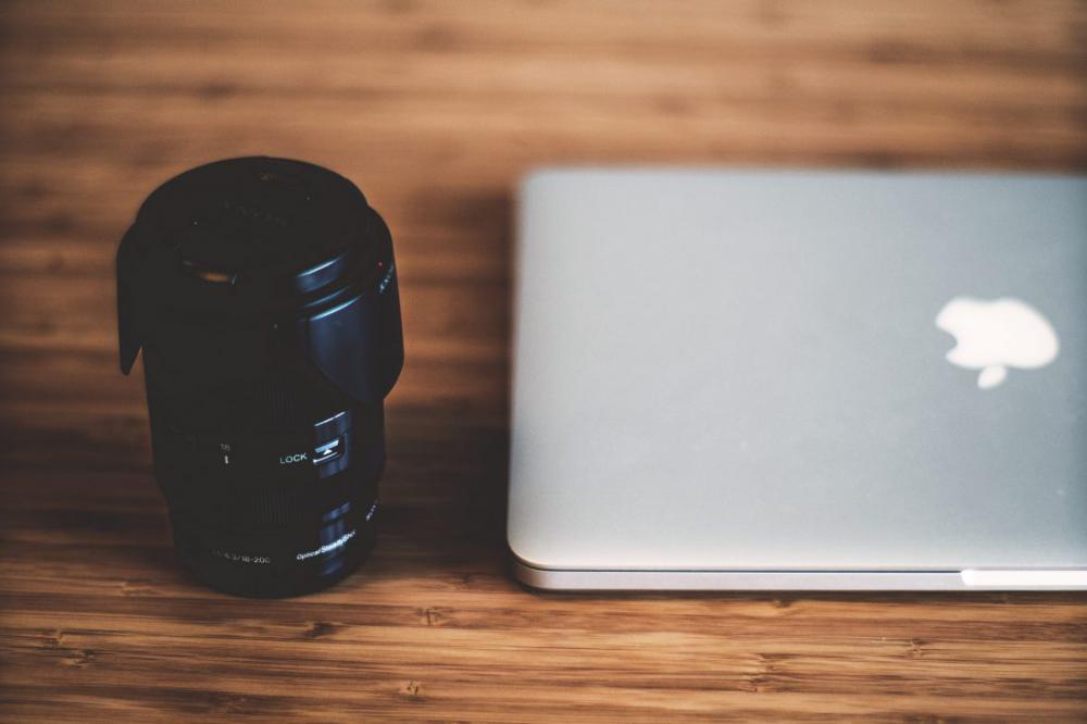 Canera Lens & MacBook Laptop on Wooden Desk Canera Lens & MacBook Laptop on Wooden Desk