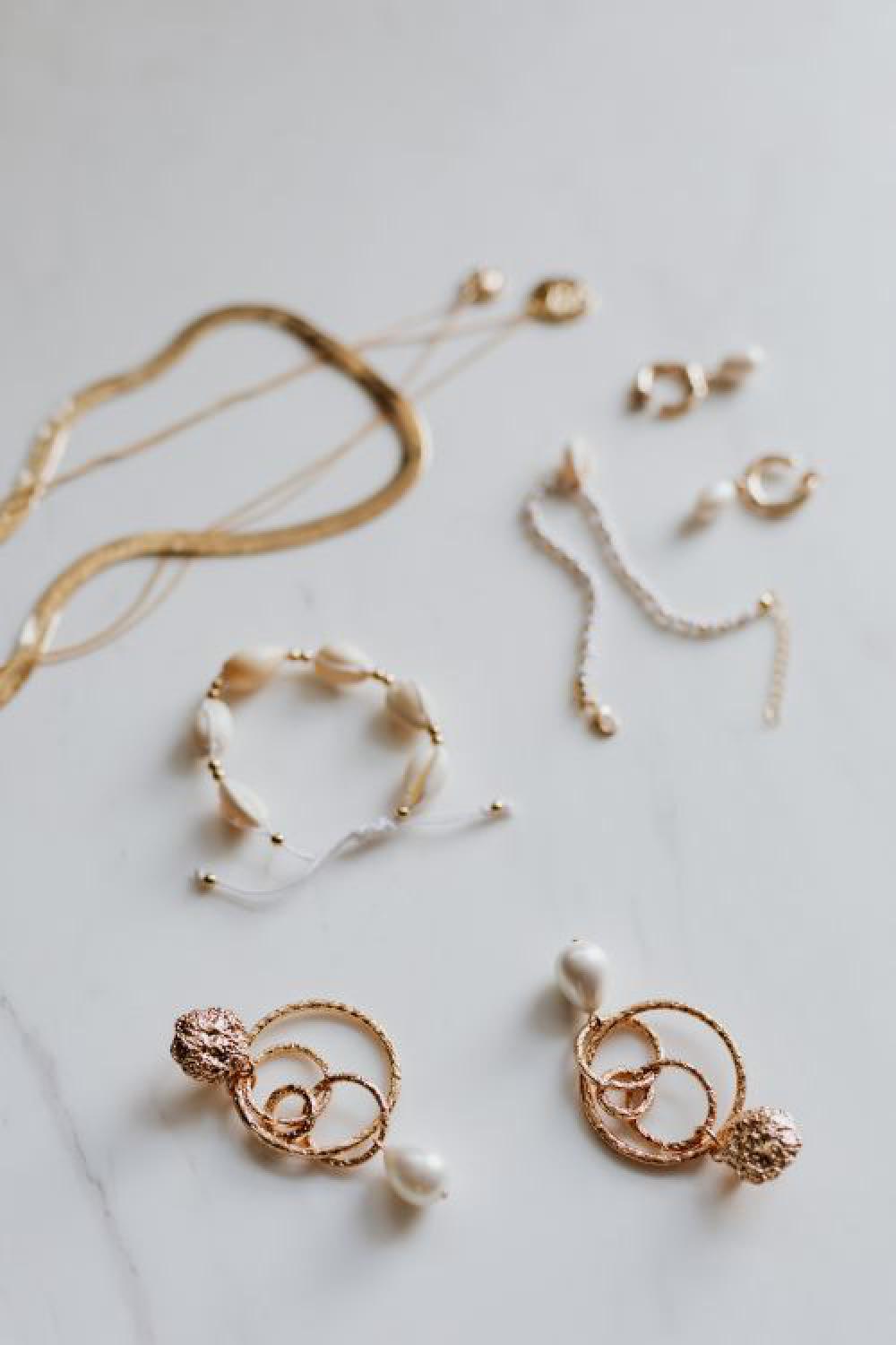 Gold jewelry on white marble Gold jewelry on white marble