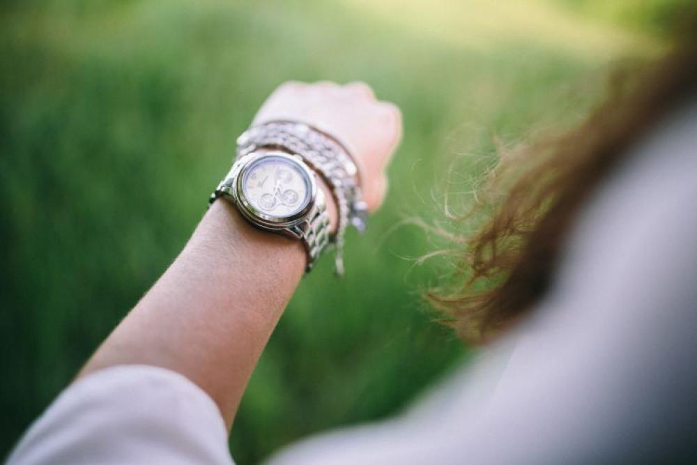 Silver watch on the girl's arm Silver watch on the girl's arm