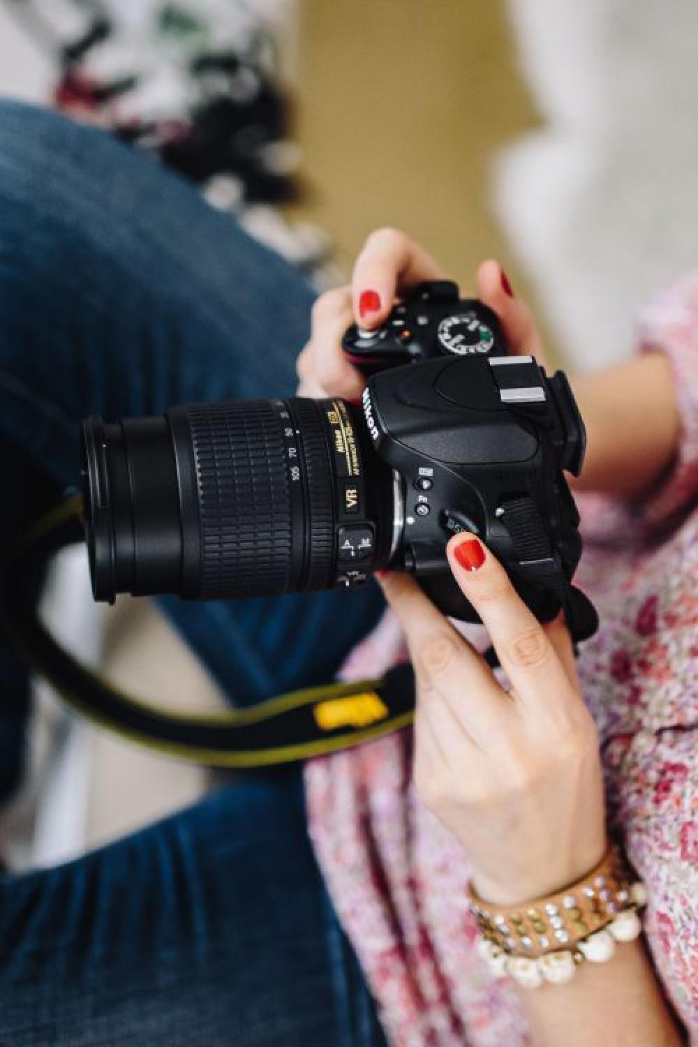 Woman in pink with her camera Woman in pink with her camera