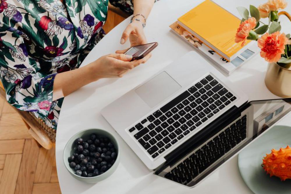 A woman works on a laptop at home A woman works on a laptop at home