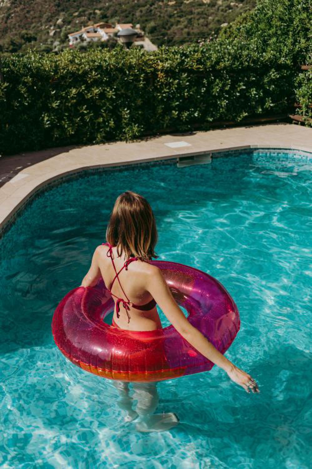 A beautiful woman in a pool with an inflatable ring A beautiful woman in a pool with an inflatable ring