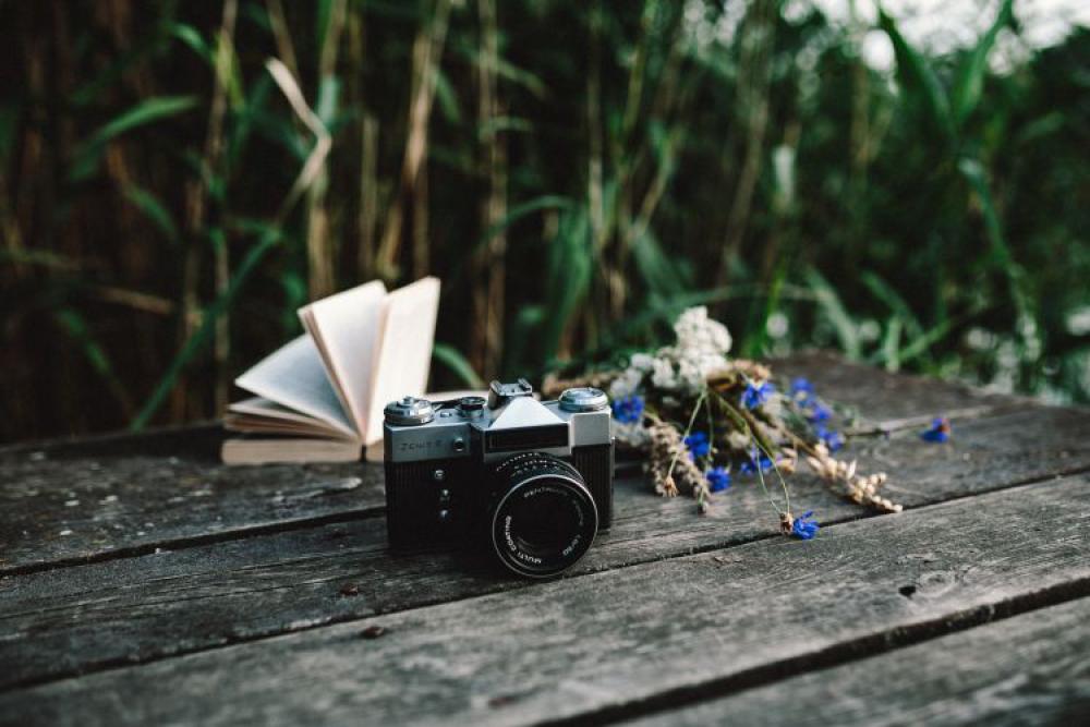 Colorful smoke bomb, book and vintage camera Colorful smoke bomb, book and vintage camera