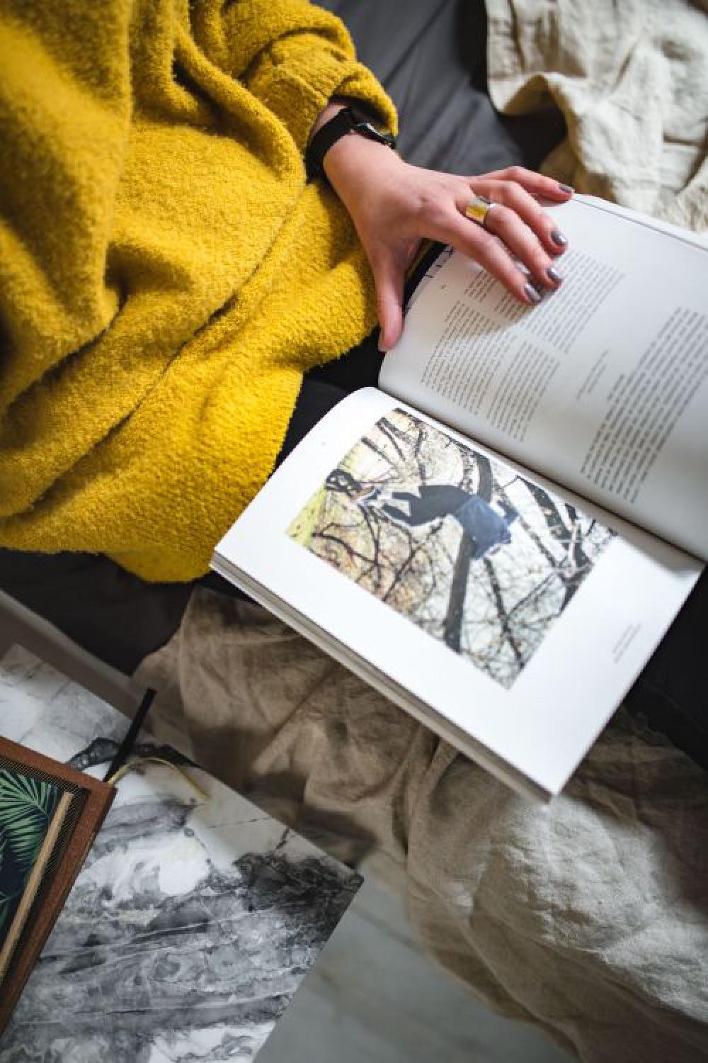 Young woman reading a magazine in bed Young woman reading a magazine in bed