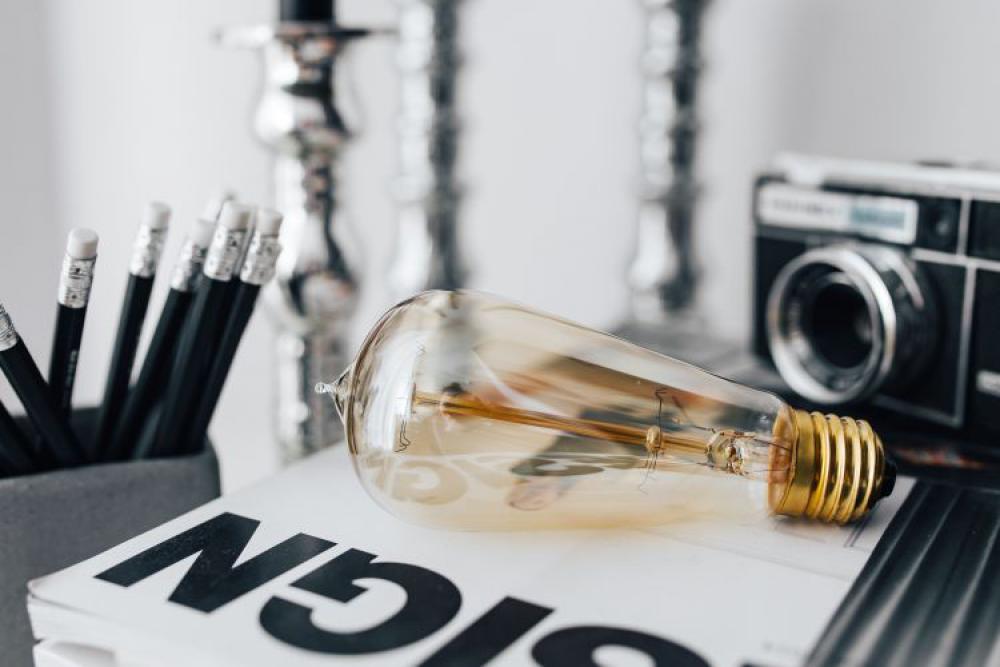 Pencils, magazines and an old lightbulb Pencils, magazines and an old lightbulb