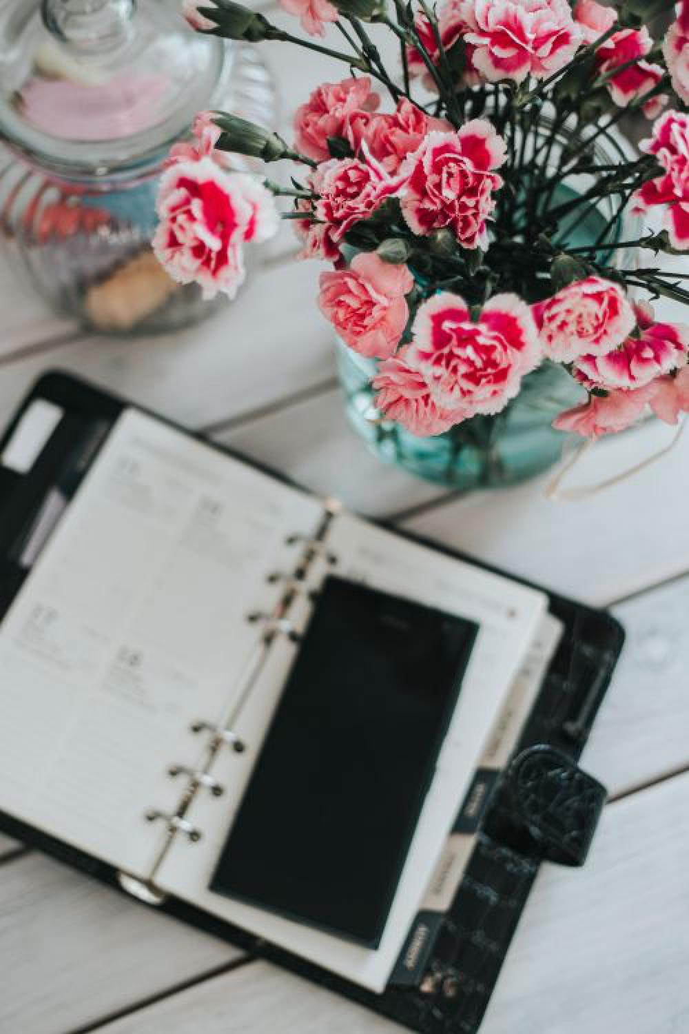 Organizer, mobile phone and lovely pink flowers Organizer, mobile phone and lovely pink flowers