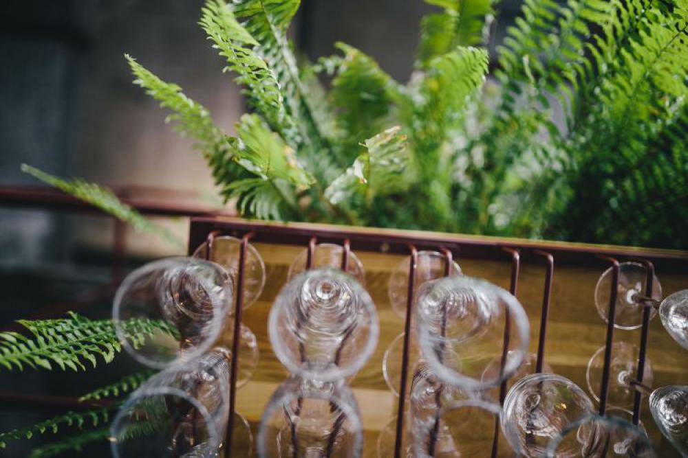 A big bunch of wine glasses hanging from a holder A big bunch of wine glasses hanging from a holder