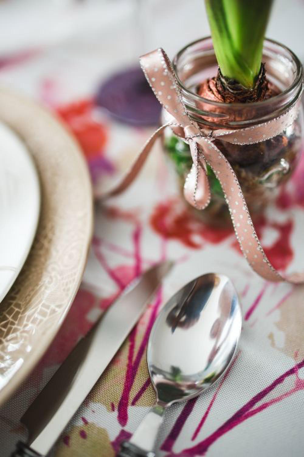 Easter table with cute pink decorations, flowers, catkins and eggs Easter table with cute pink decorations, flowers, catkins and eggs