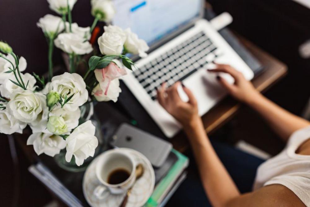 Woman working on laptop at home office Woman working on laptop at home office