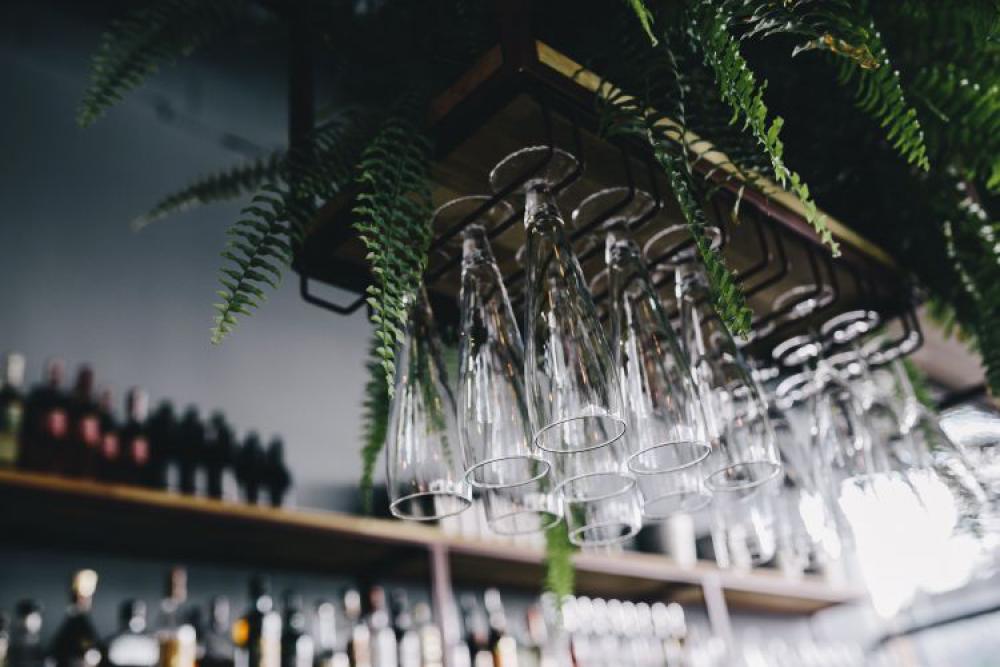 A big bunch of wine glasses hanging from a holder A big bunch of wine glasses hanging from a holder