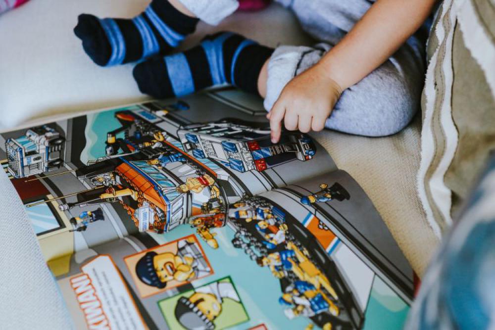 Child reading a comic story Child reading a comic story