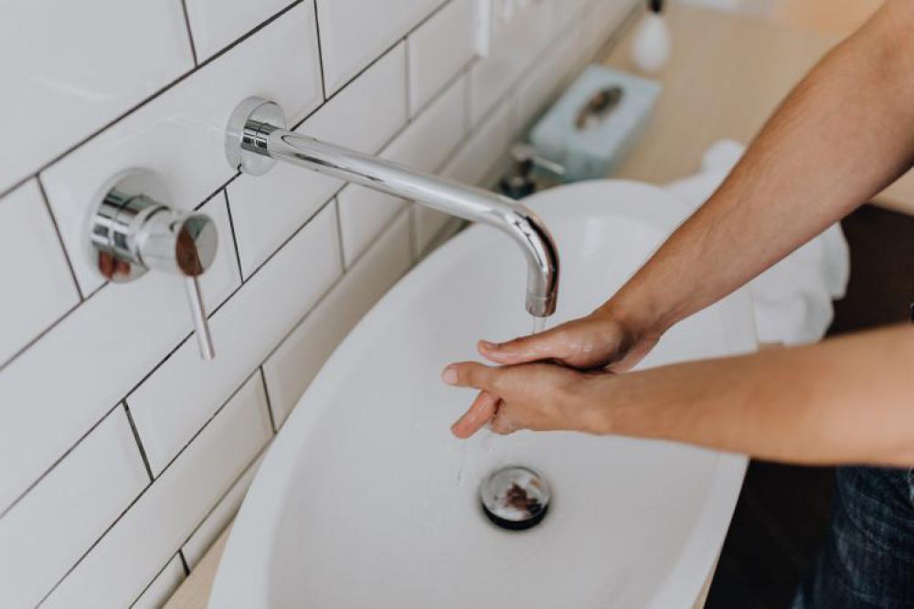 Washing of hands under running water Washing of hands under running water