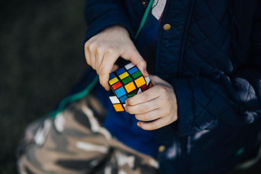 Boy in a blue jacket holding things Boy in a blue jacket holding things