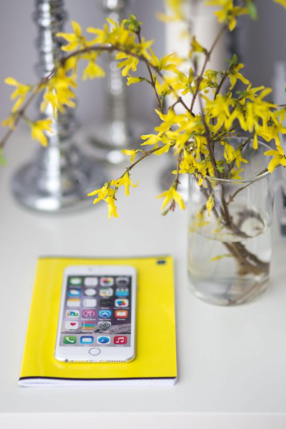 White smartphone with yellow flowers White smartphone with yellow flowers