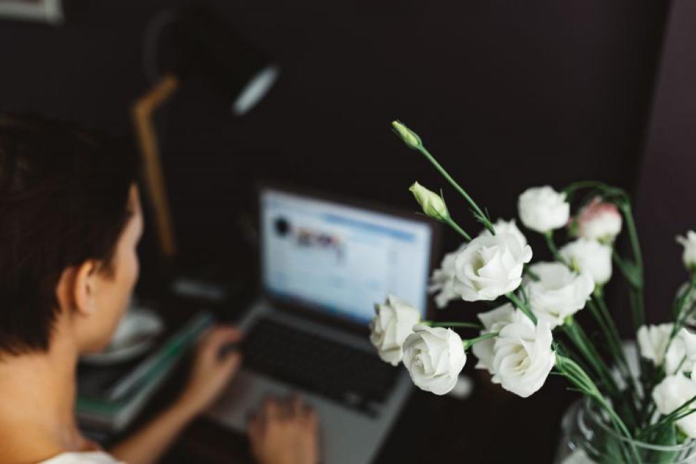 Woman working on laptop at home office Woman working on laptop at home office