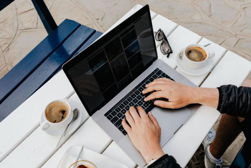 Working with a laptop by the sea. Cup of coffee and delicious tiramisu, Marina di Puolo, Italy Working with a laptop by the sea. Cup of coffee and delicious tiramisu, Marina di Puolo, Italy