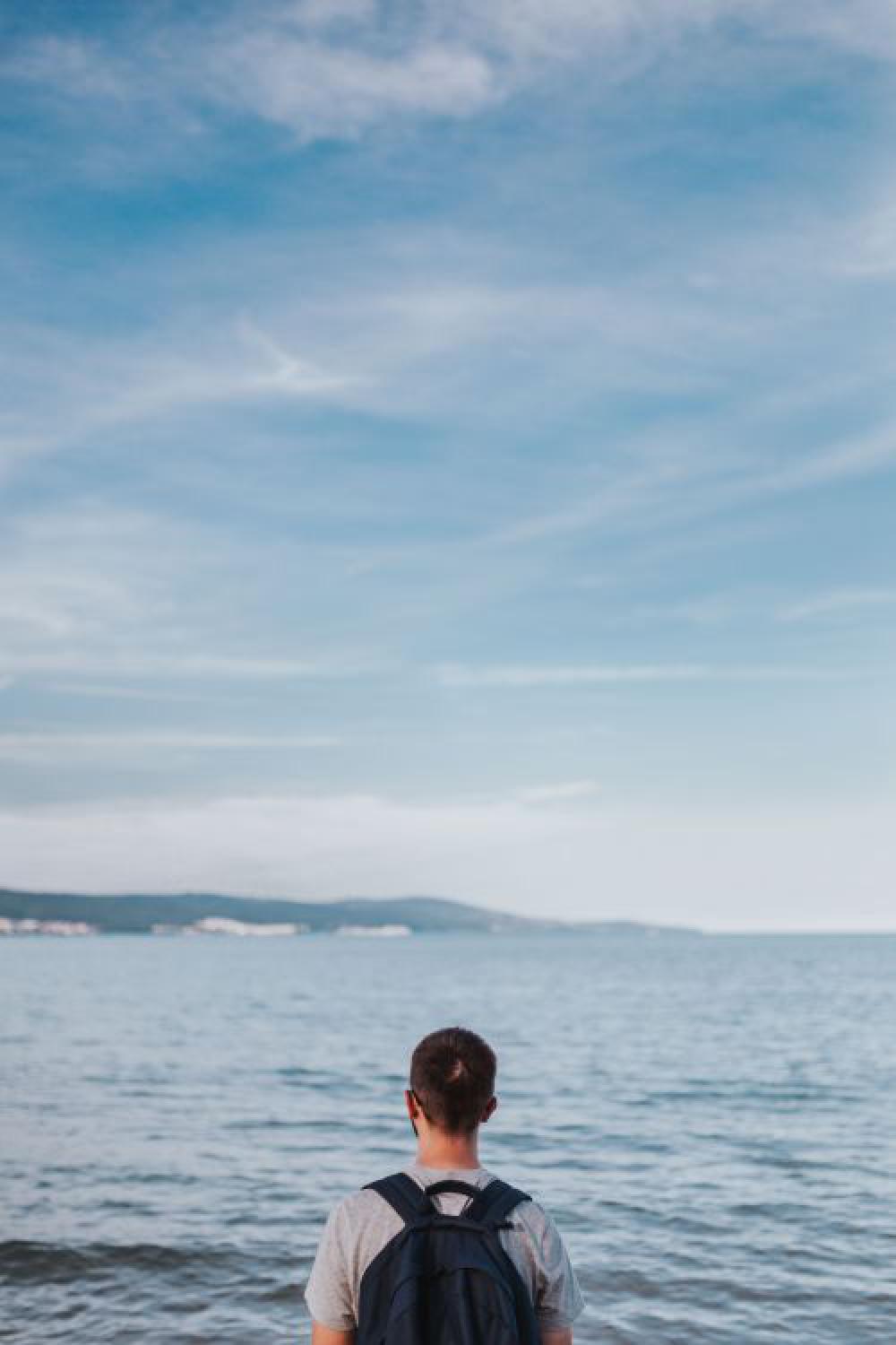 Man looking out to sea Man looking out to sea