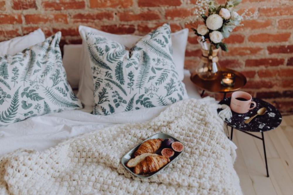 A lovely woman's bedroom with a beautiful bouquet of flowers A lovely woman's bedroom with a beautiful bouquet of flowers