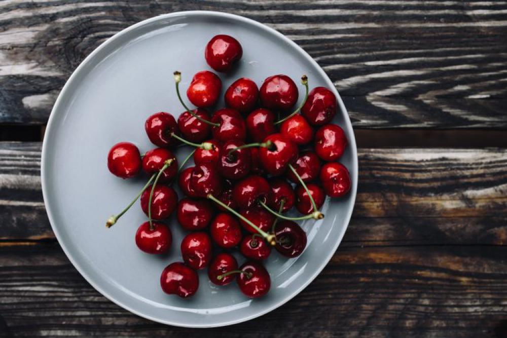 Fresh Cherries on a simple plate Fresh Cherries on a simple plate