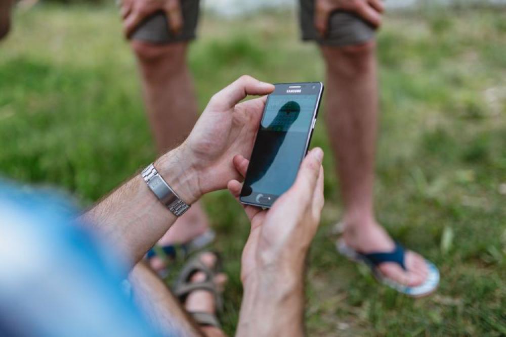 Closeup of man hands playing videogames on cell phone Closeup of man hands playing videogames on cell phone