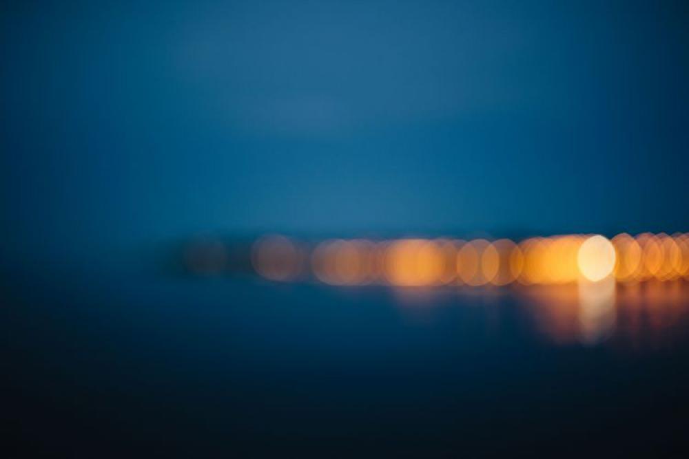 City lights reflected in the water at night City lights reflected in the water at night