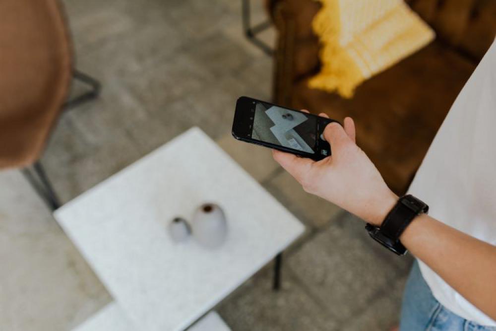 A man with a watch on his wrist is using his phone A man with a watch on his wrist is using his phone