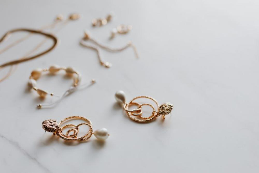 Gold jewelry on white marble Gold jewelry on white marble