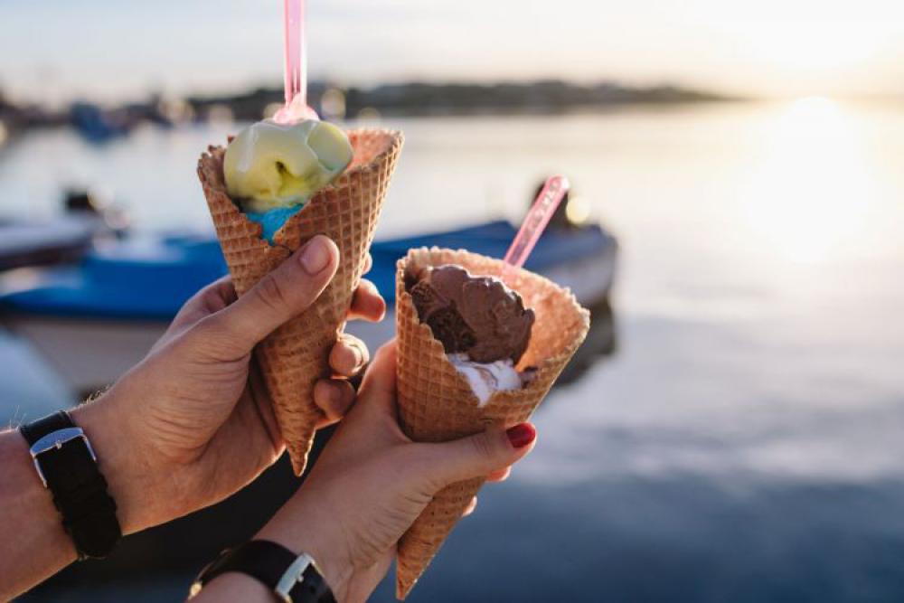 Man and Woman Holding Ice Creams Man and Woman Holding Ice Creams