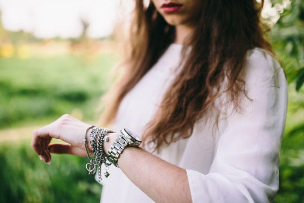 Silver watch on the girl's arm Silver watch on the girl's arm