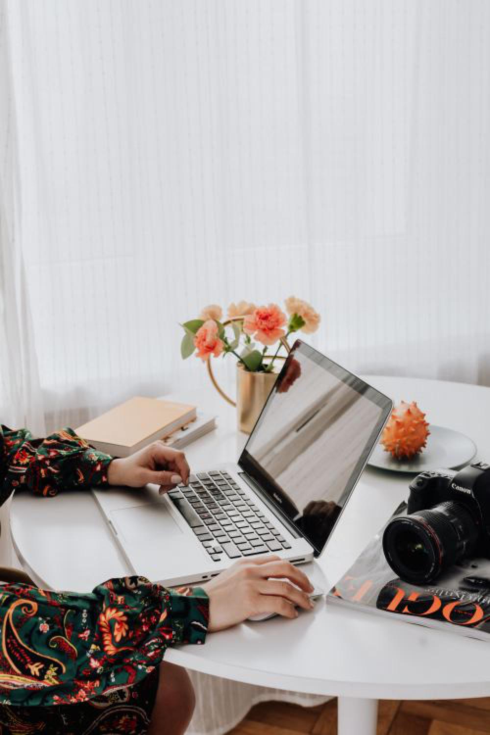 A woman works on a laptop at home A woman works on a laptop at home