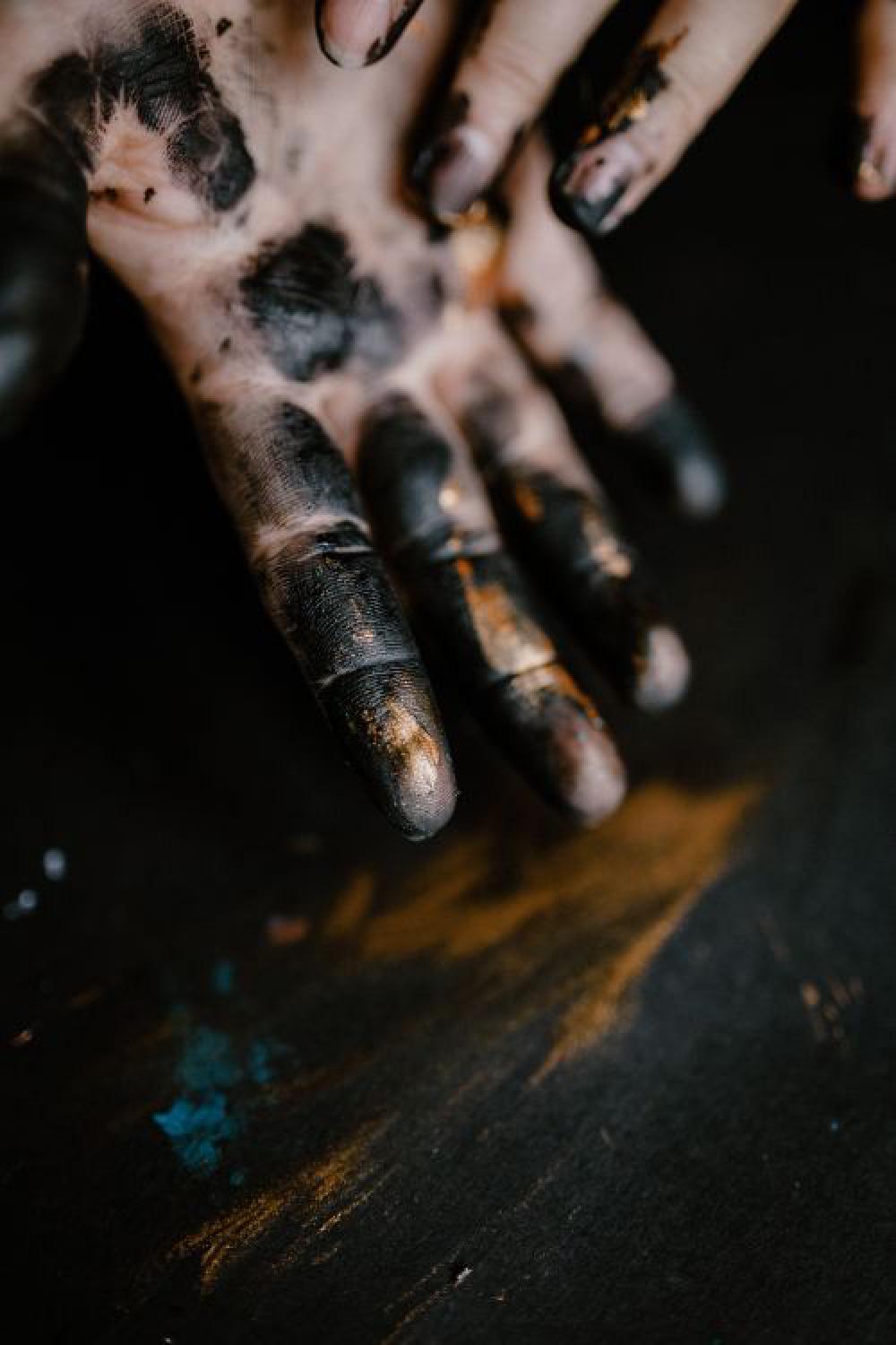 Messy painted hands of a painting artist Messy painted hands of a painting artist