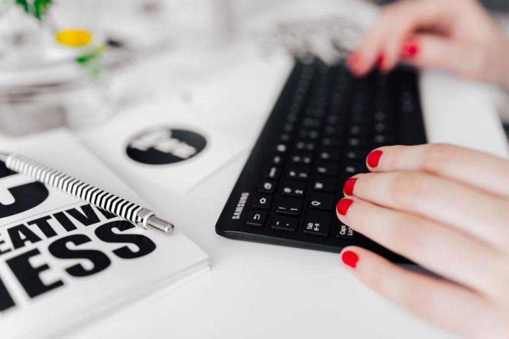 Female hands typing on the remote wireless computer keyboard Female hands typing on the remote wireless computer keyboard