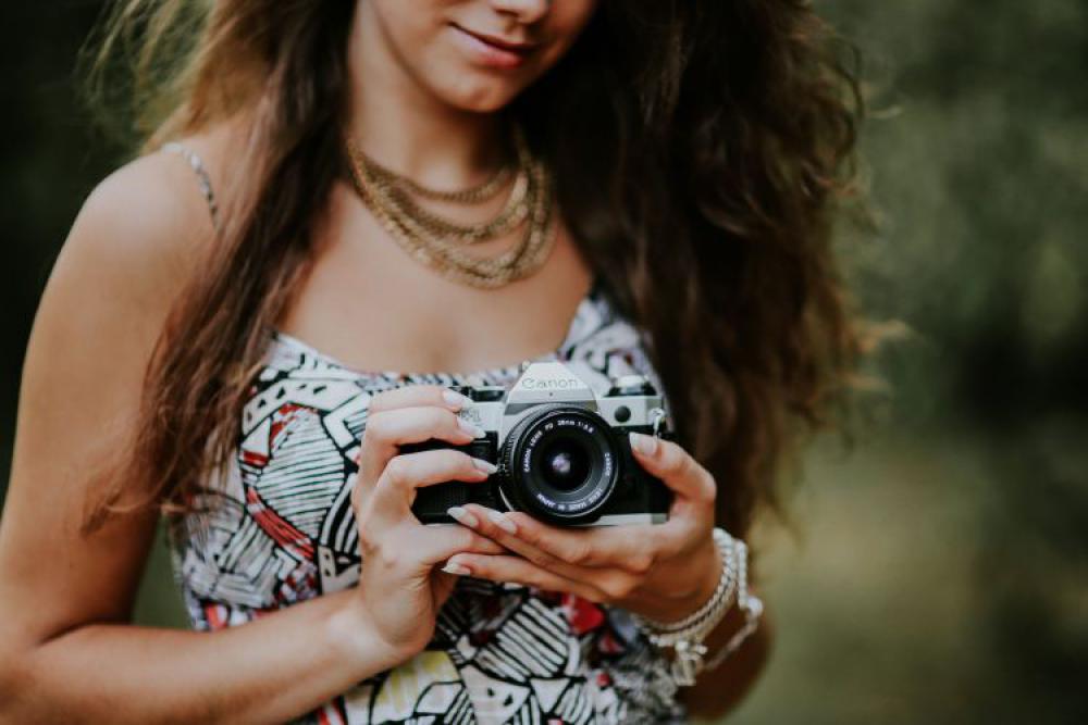 Woman in a dress with a camera Woman in a dress with a camera