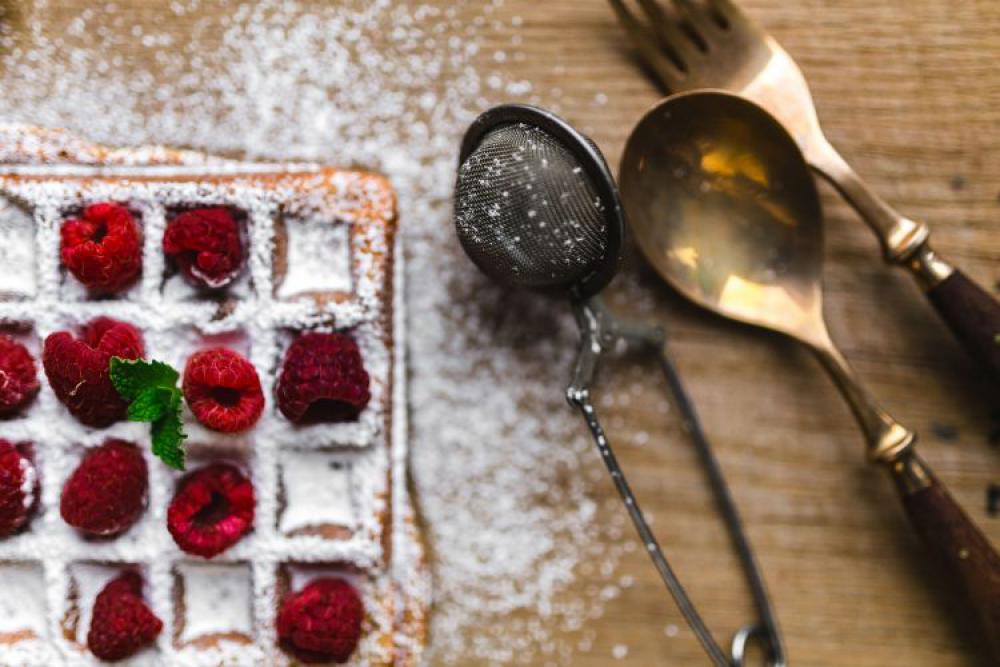 Breakfast waffles with fresh raspberries and powdered sugar Breakfast waffles with fresh raspberries and powdered sugar