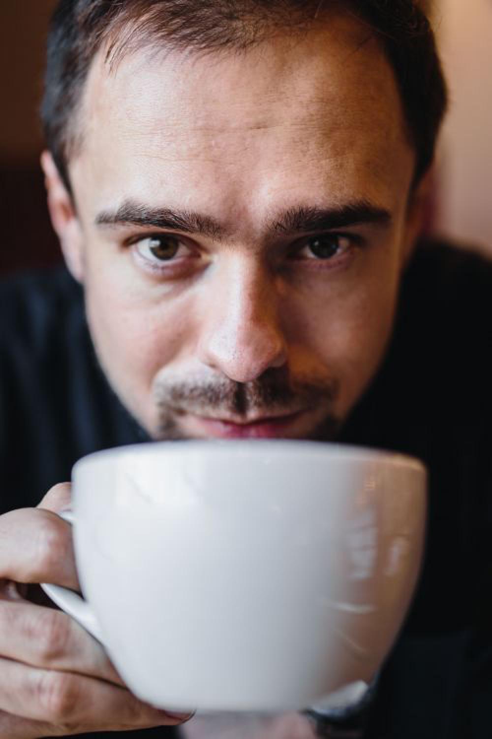 Young Elegantly dressed man sititng in a cafe Young Elegantly dressed man sititng in a cafe