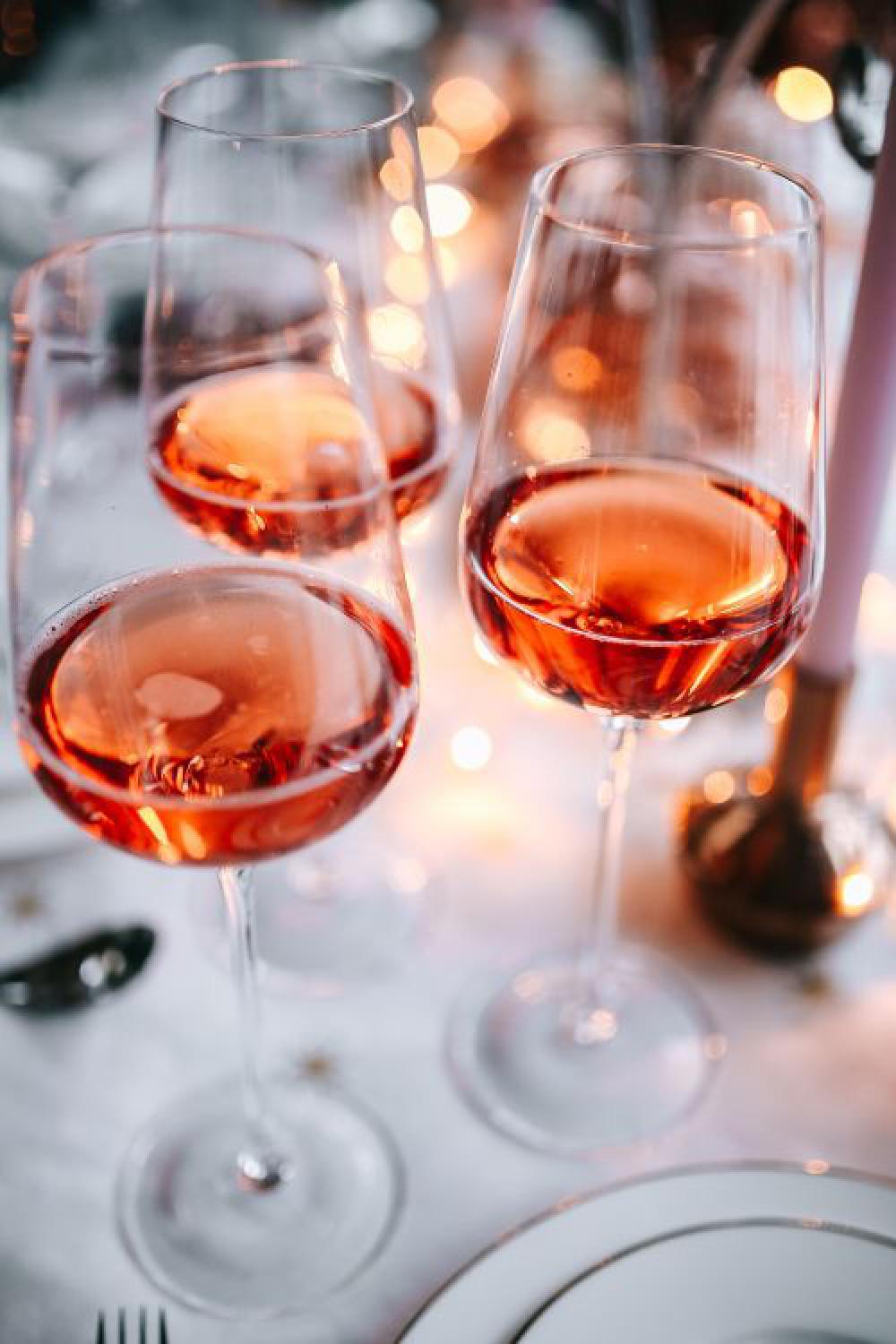 Rose wine glass on christmas table Rose wine glass on christmas table
